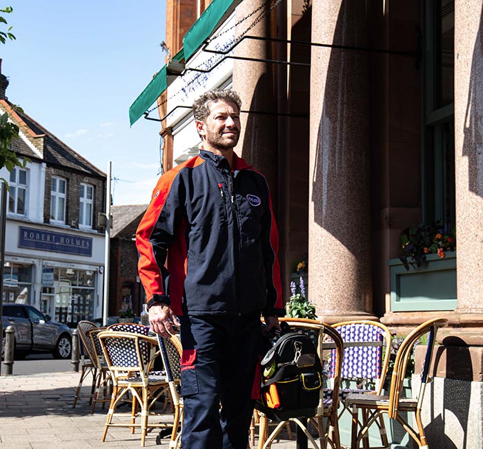 Pimlico engineer walking down a street in Wimbledon, Merton