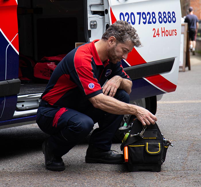 Pimlico engineer by his van in Sutton