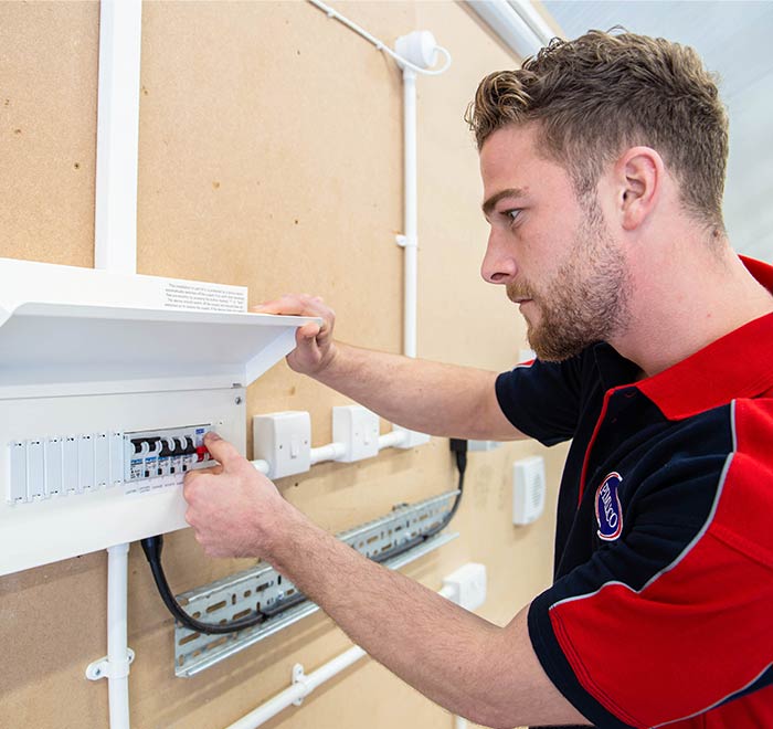 Electrician working on fuseboard