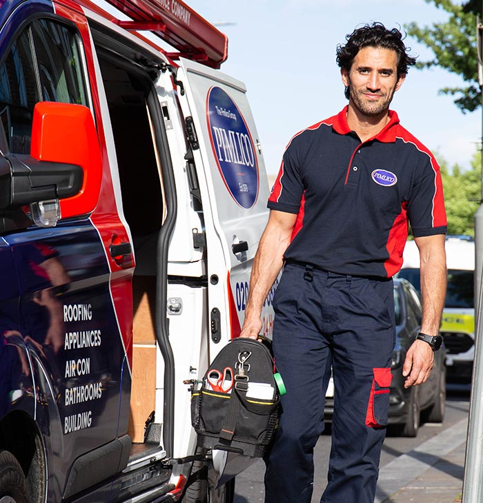 Pimlico engineer standing by his van