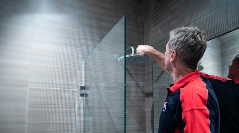 A Pimlico engineer checks the fitting of a shower head