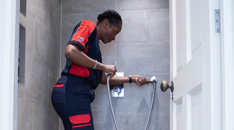 A Pimlico engineer tests the water pressure of a shower