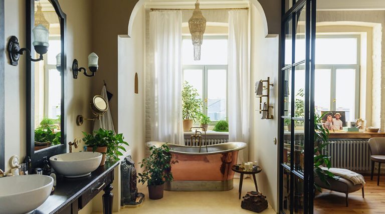 Matte black bathroom design with plants, furniture combined with modern copper features