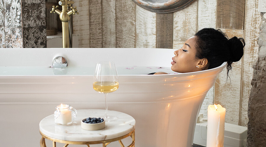 Woman relaxing in a French bathroom design bathtub