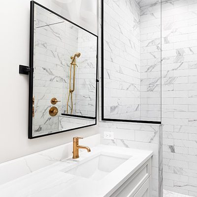 Minimal white bathroom with gold fittings