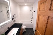 White bathroom with black floor tiles