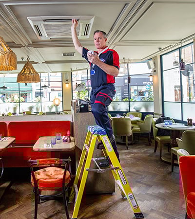 Pimlico air con technician testing a air con unit