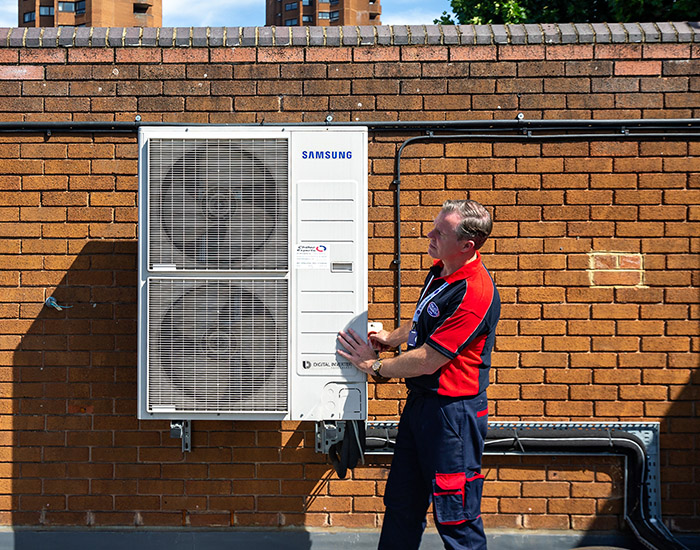 Pimlico air con technician fixing a air con unit
