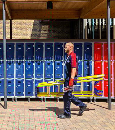 Pimlico pest control technician walking with bird spikes