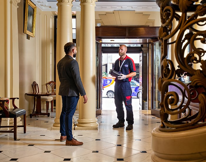 Pimlico engineer talking to a receptionist at a embassy