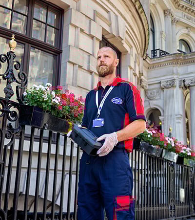 Pimlico pest control technician with rat trap