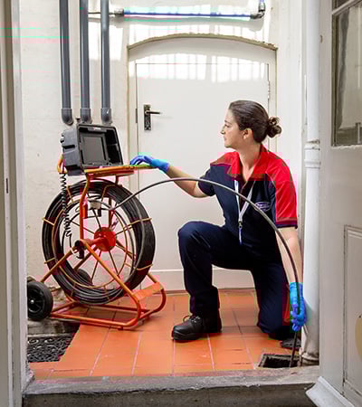 Pimlico drainage engineer inspecting a drain