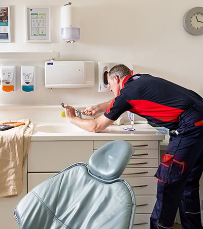 Pimlico plumber fixing a tap in a dentist
