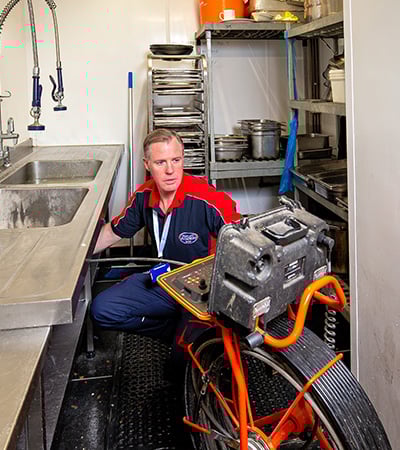 Pimlico drainage engineer checking drainage under a kitchen sink