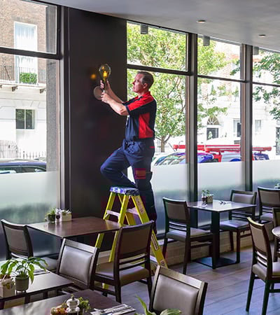Pimlico electrician working on a light