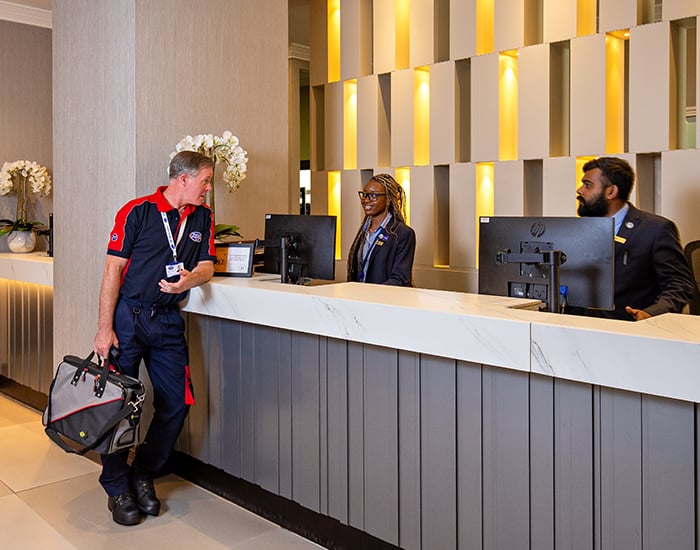 Pimlico engineer talking to hotel receptionists