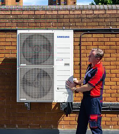 Pimlico air con technician checking an external unit
