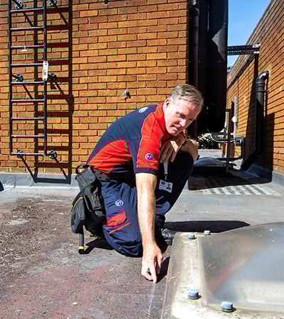 Pimlico roofer inspecting a skylight