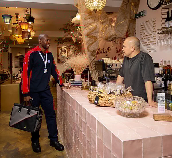 Pimlico engineer talking to a shop owner
