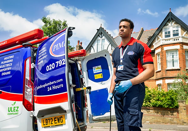Drainage expert standing by Pimlico van