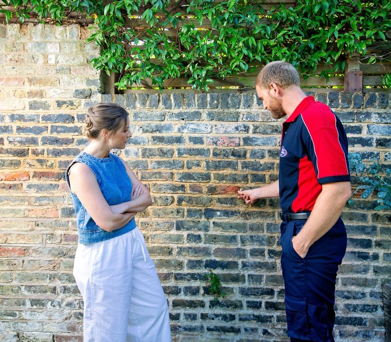 Man inspecting wall
