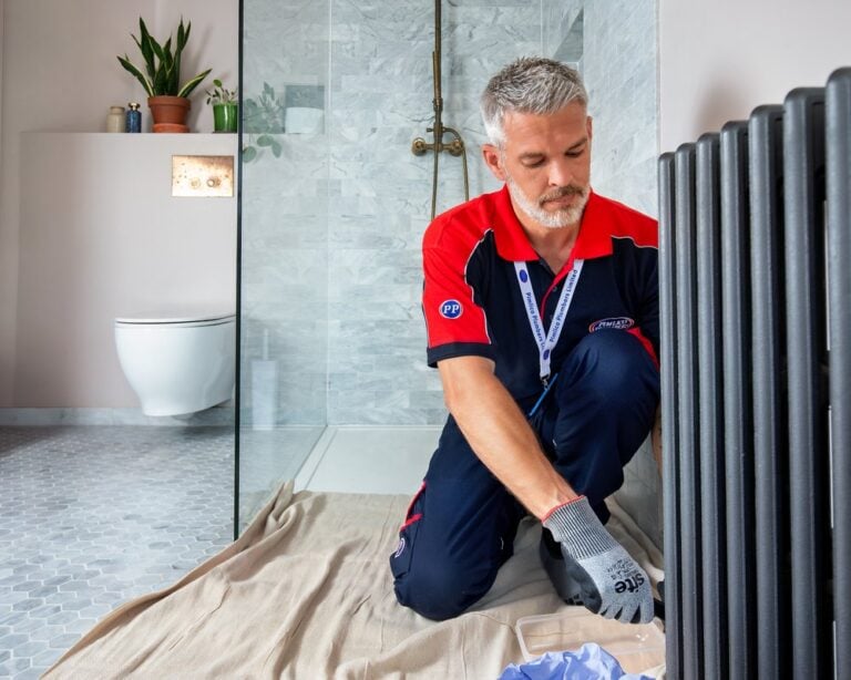 man extracting water from central heating