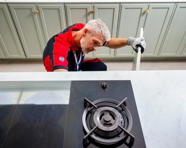 man checking below the cupboard