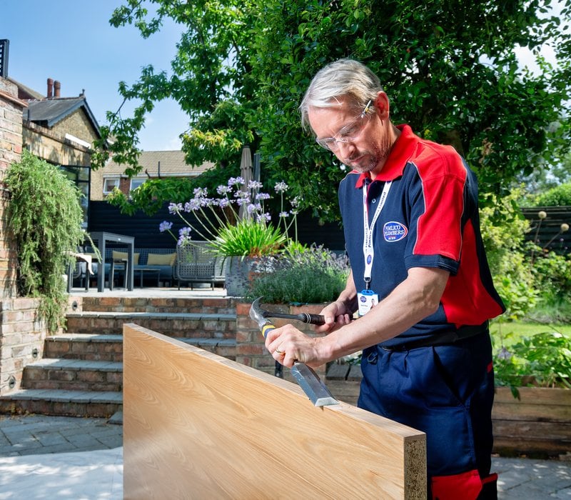 Man repairing door in the garden